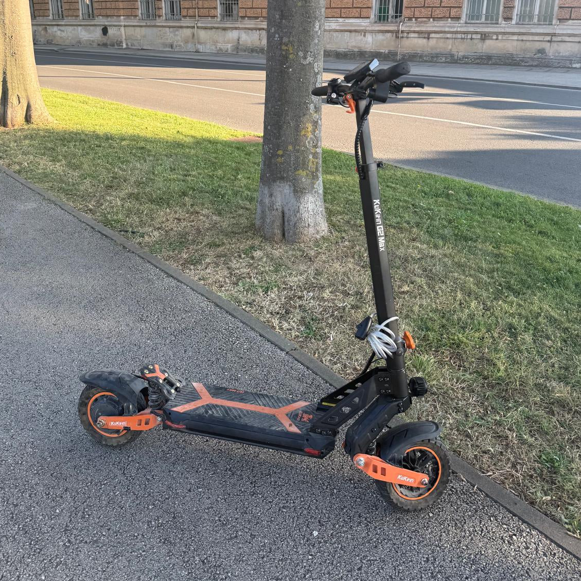 Electric scooter on a sidewalk with a building in the background